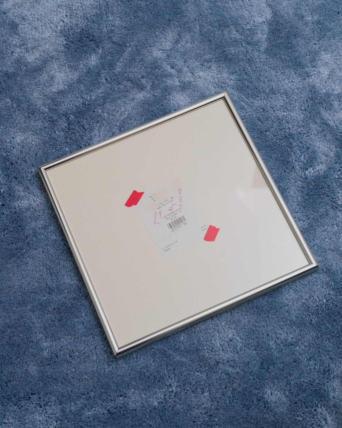 Bare in Chrome with a handwritten note on a receipt, lying on a blue rug